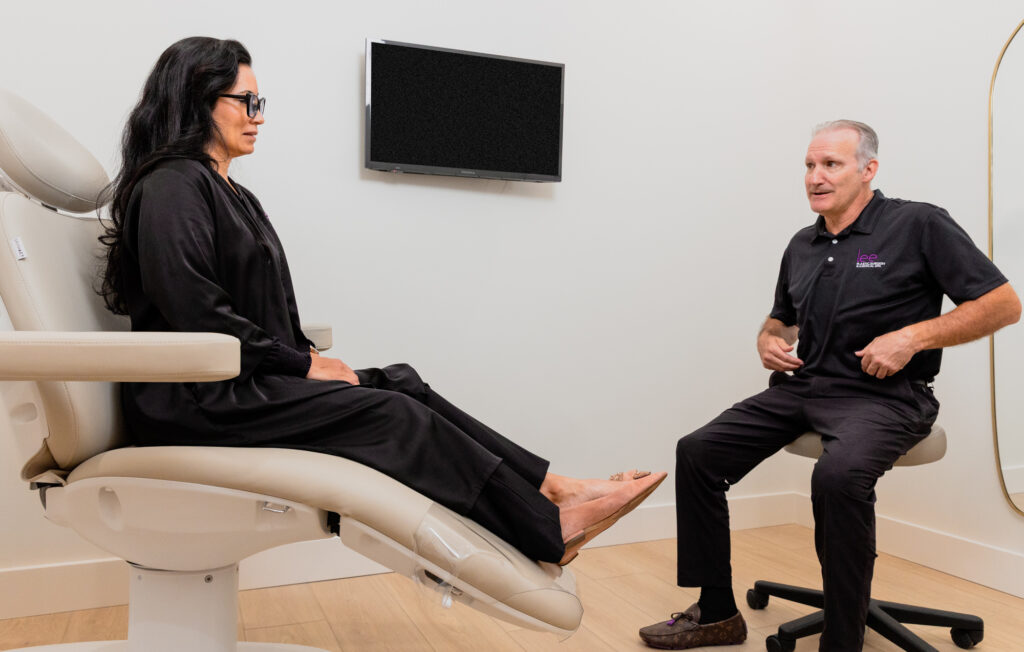 A woman sits down for a consultation with Dr. Lee to discuss hormone replacement therapy near Palm City.