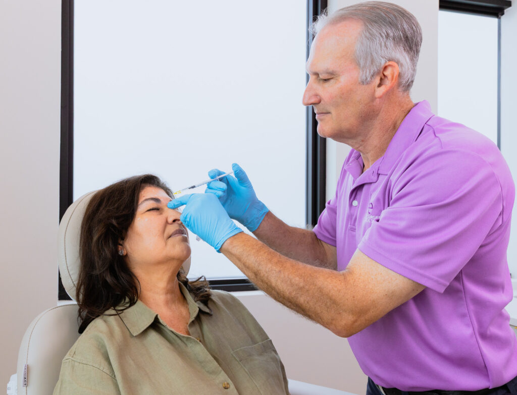 Dr. Lee injects Botox near Palm City into a woman's forehead.
