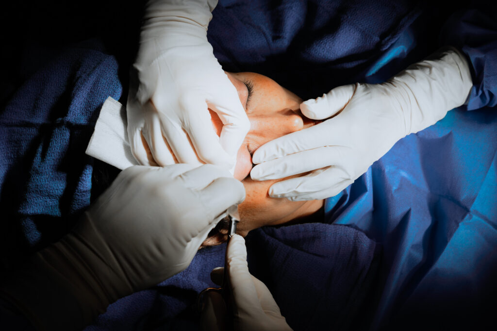 A patient lies down in the operating room to undergo a facelift near Jupiter Island.