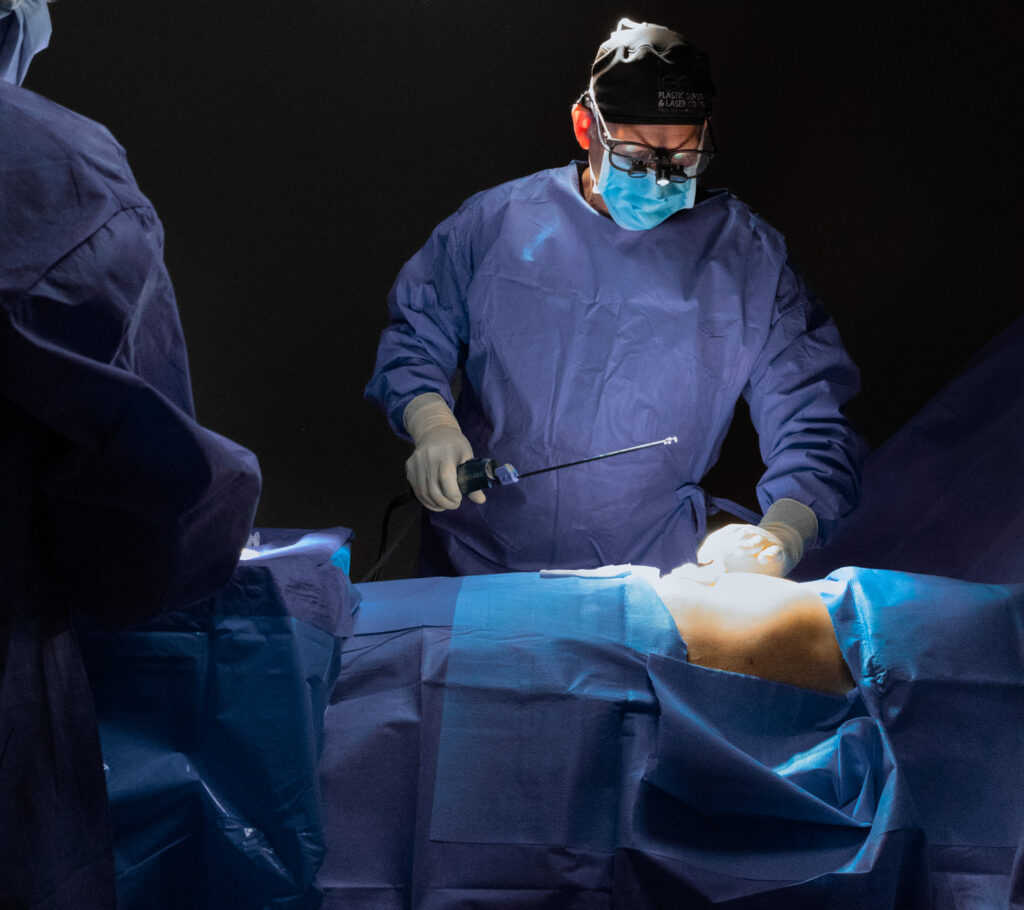 Dr. Lee holds a cannula as he performs liposuction near Palm City