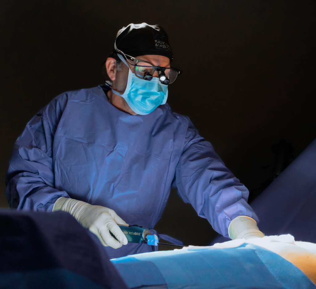 A provider in surgical garb performs liposuction near Palm City