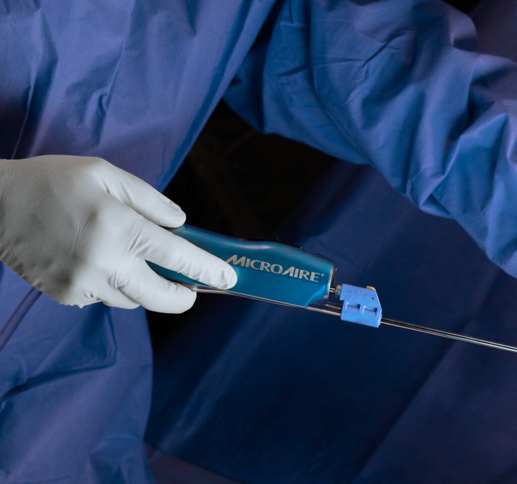 A provider wearing gloves holds a cannula during liposuction near Palm City